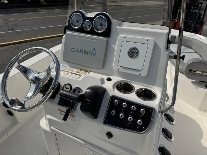 Slide: The Image of 2023 NauticStar 191 Hybrid boat console with Garmin navigation system and steering wheel. - 7