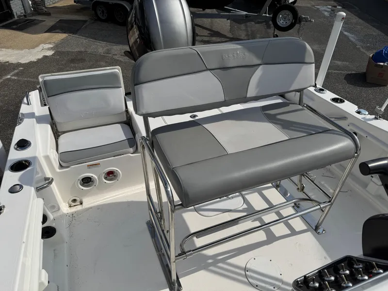 Slide: The Image of 2023 NauticStar 191 Hybrid boat interior with gray seating and console. - 8