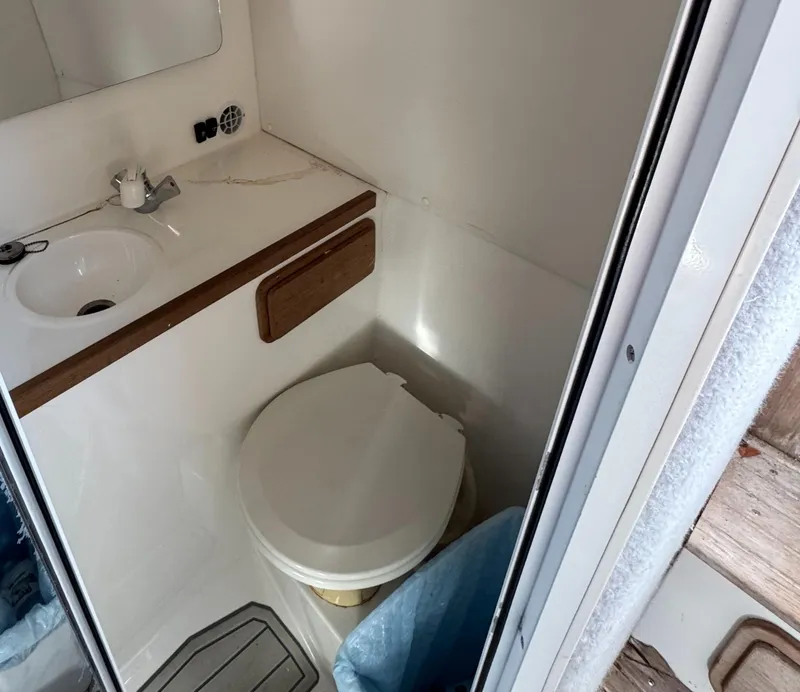 Slide: The Image of 2001 Contender 35 Side Console boat bathroom with sink and toilet. - 10