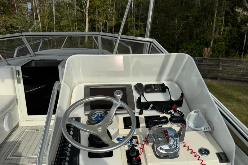 Slide: The Image of 2001 Contender 35 Side Console boat helm with steering wheel and controls. - 7