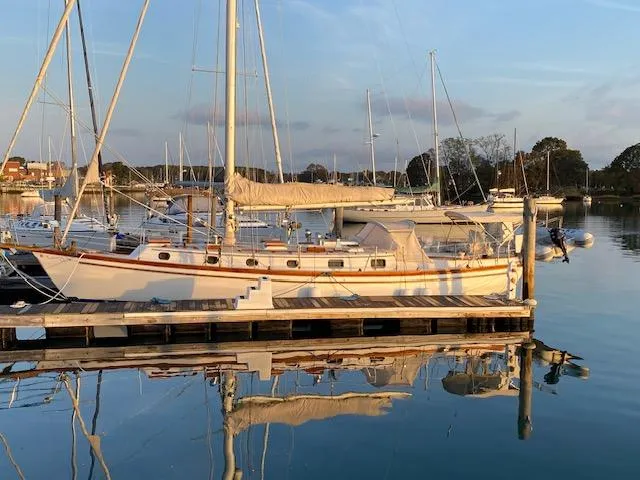 The Image of Sailboat docked at marina, Shannon 43 model, 1988, reflecting on calm water. - 0
