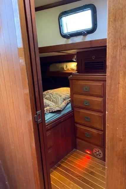 Slide: The Image of Cozy cabin interior of 1988 Shannon 43 sailboat with wooden drawers and bedding. - 10
