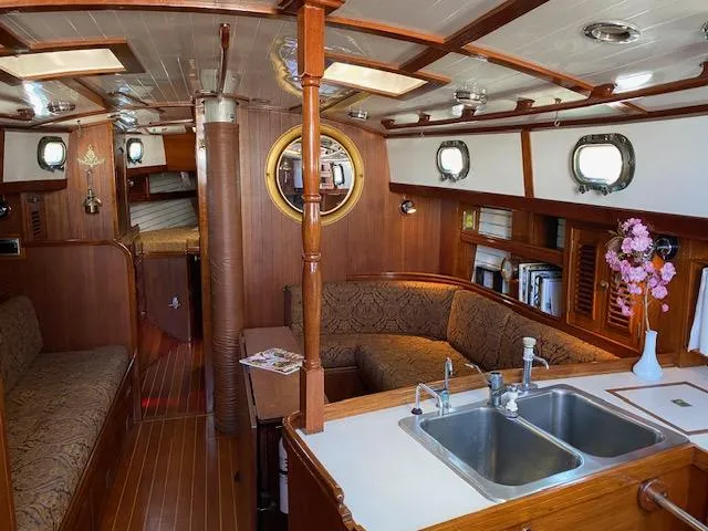 Slide: The Image of Interior of a 1988 Shannon 43 sailboat with wood finish and cozy seating area. - 11