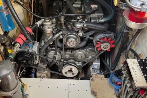 Slide: The Image of Engine compartment of a 1988 Shannon 43 boat, showcasing mechanical components and wiring. - 15