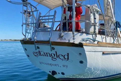 Slide: The Image of Sailboat "Entangled" docked in calm waters, Greenport, NY, Shannon 43, 1988 model. - 3