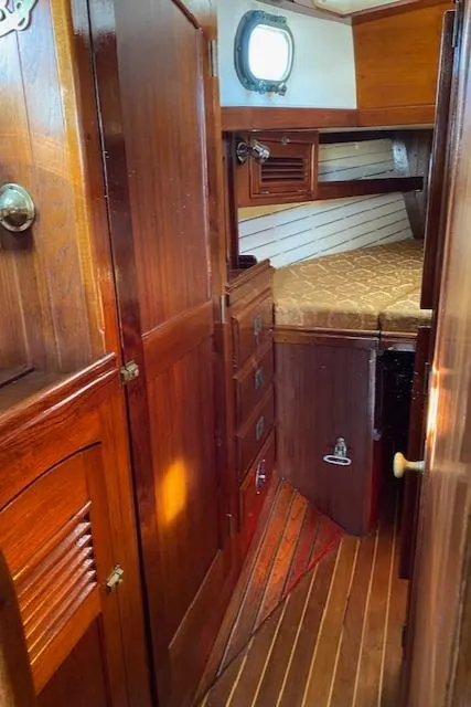 Slide: The Image of 1988 Shannon 43 yacht interior with wooden cabinetry and cozy sleeping area. - 8