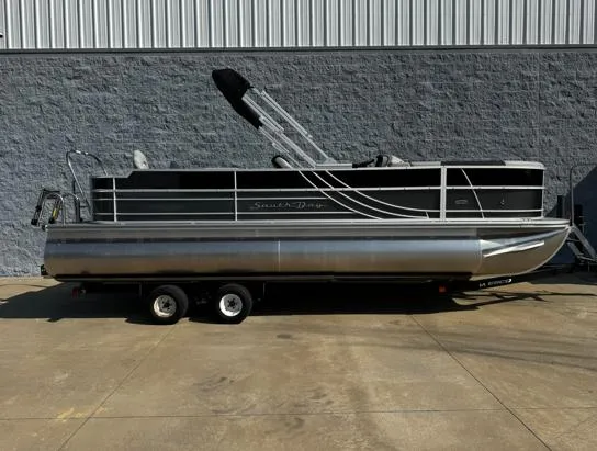 Slide: The Image of 2025 South Bay 224RS LE pontoon boat on trailer, parked outdoors. - 1