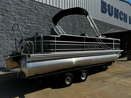 Slide: The Image of 2025 South Bay 224RS LE pontoon boat on trailer outside dealership. - 10