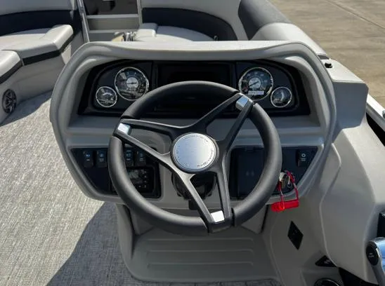 Slide: The Image of 2025 South Bay 224RS LE boat dashboard with steering wheel and gauges. - 4