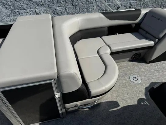 Slide: The Image of 2025 South Bay 224RS LE boat interior with gray seating and storage compartment. - 5