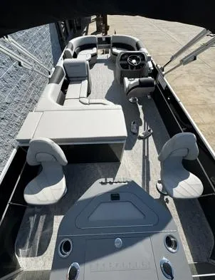 Slide: The Image of 2025 South Bay 224RS LE pontoon boat interior with modern seating and steering console. - 6