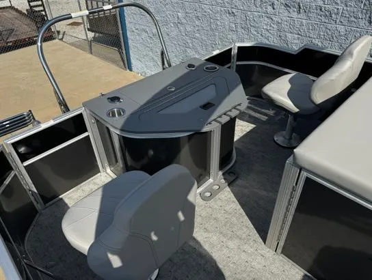 Slide: The Image of 2025 South Bay 224RS LE pontoon boat interior with seating and control console. - 7