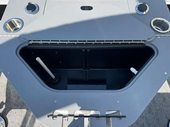 Slide: The Image of 2025 South Bay 224RS LE boat storage compartment with cup holders and utility features. - 8