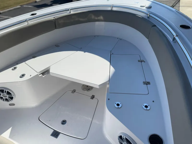 Slide: The Image of 2024 Sportsman Open 252 Center Console boat interior with storage compartments and seating. - 10