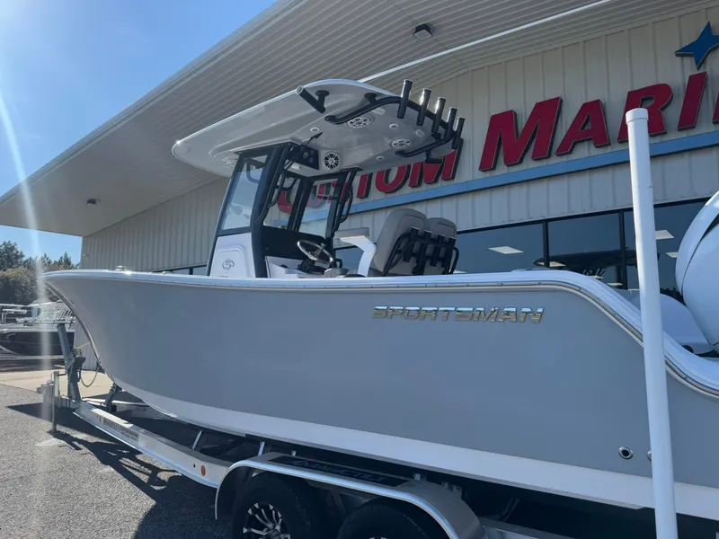 Slide: The Image of 2024 Sportsman Open 252 Center Console boat displayed outside a marine dealership. - 3