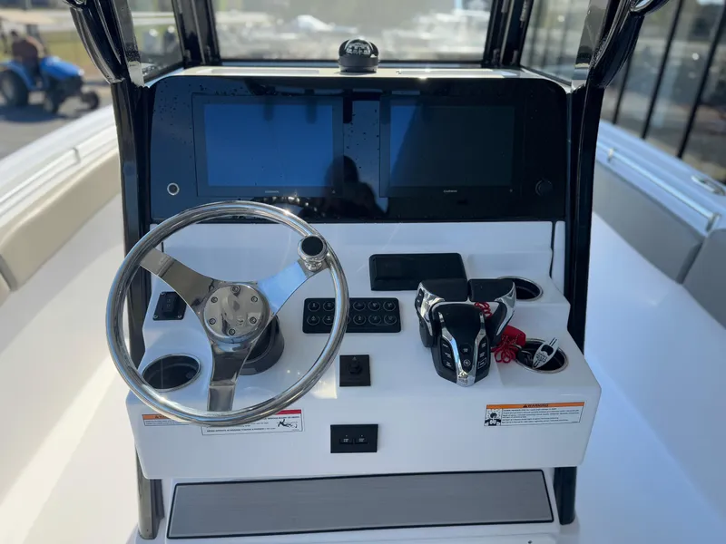 Slide: The Image of 2024 Sportsman Open 252 Center Console dashboard with steering wheel and controls. - 5