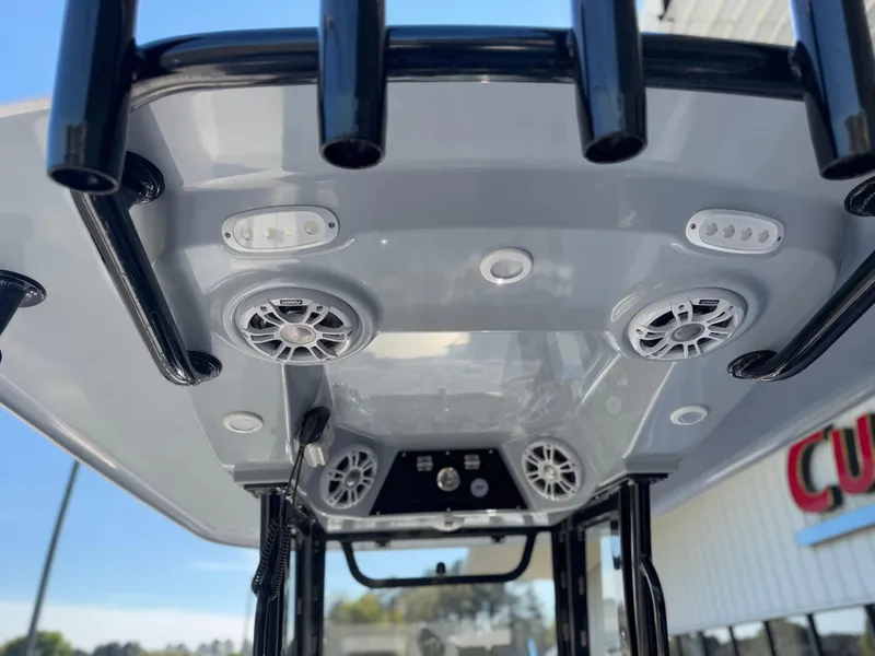 Slide: The Image of 2024 Sportsman Open 252 Center Console boat with speakers and rod holders. - 6