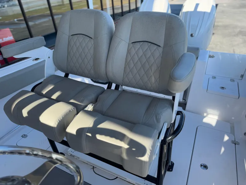 Slide: The Image of 2024 Sportsman Open 252 Center Console boat seats with diamond stitching and armrests. - 7