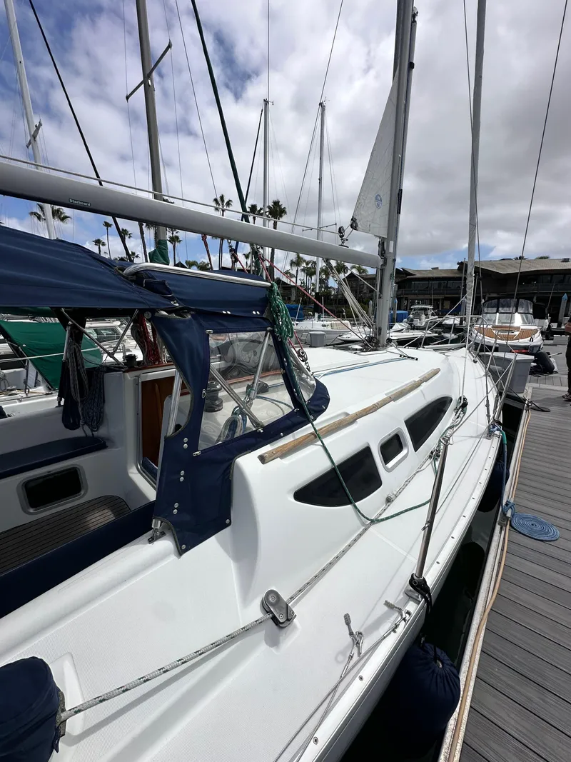 Slide: The Image of 2003 Jeanneau Sun Odyssey 32 sailboat docked at marina under cloudy sky. - 12