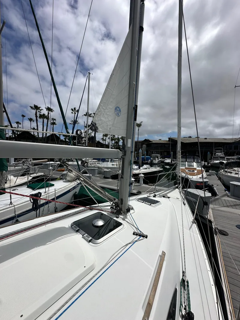 Slide: The Image of 2003 Jeanneau Sun Odyssey 32 sailboat docked at marina under cloudy sky. - 13