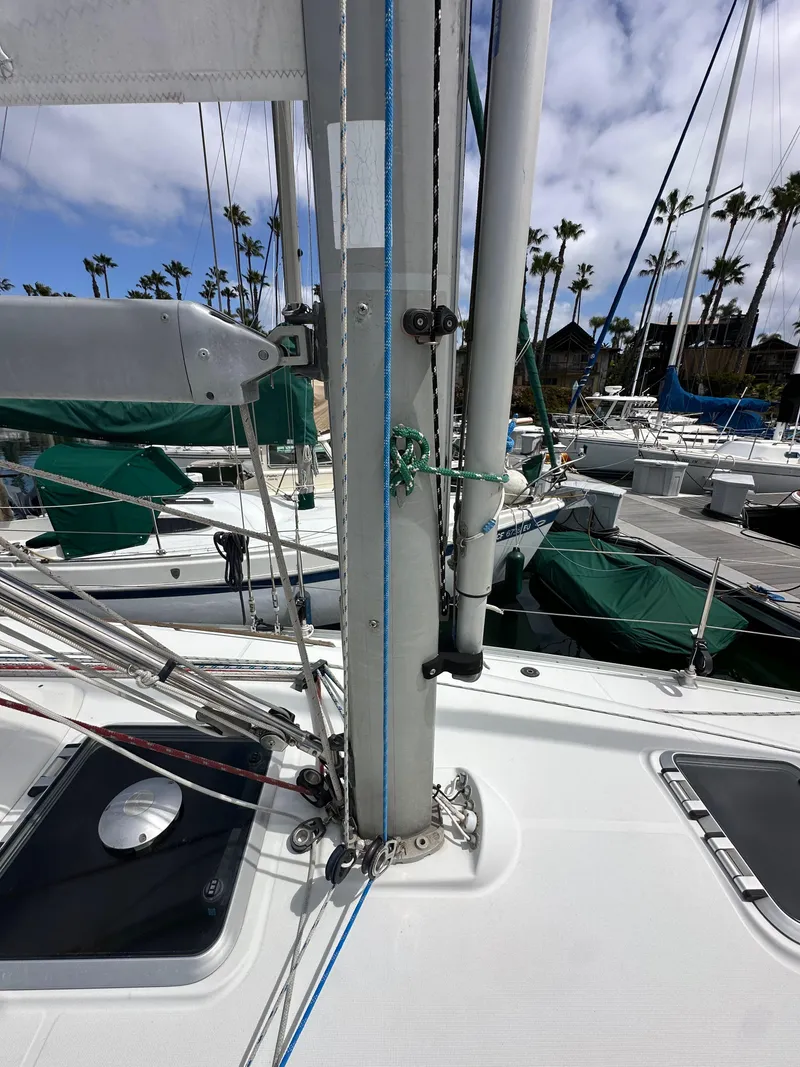 Slide: The Image of 2003 Jeanneau Sun Odyssey 32 sailboat deck with mast and rigging, docked at marina. - 14