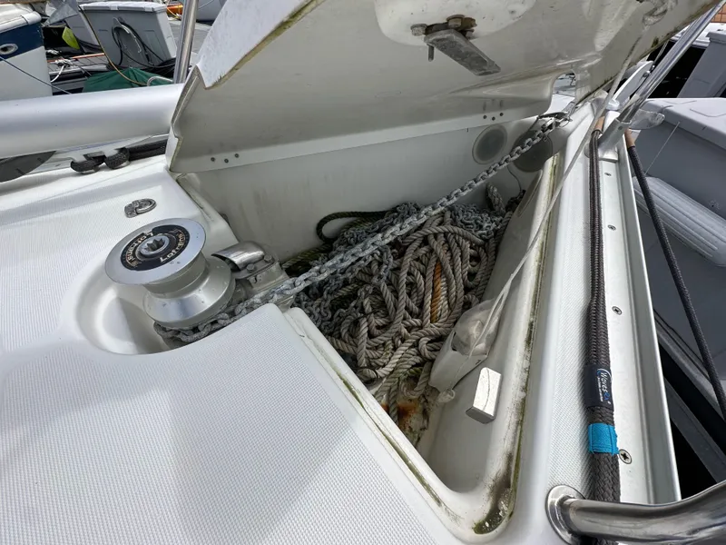 Slide: The Image of Open anchor locker on 2003 Jeanneau Sun Odyssey 32 sailboat, showing ropes and chain. - 16
