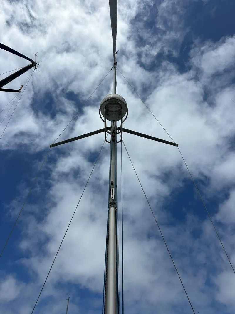 Slide: The Image of Mast of 2003 Jeanneau Sun Odyssey 32 sailboat against a cloudy sky. - 19