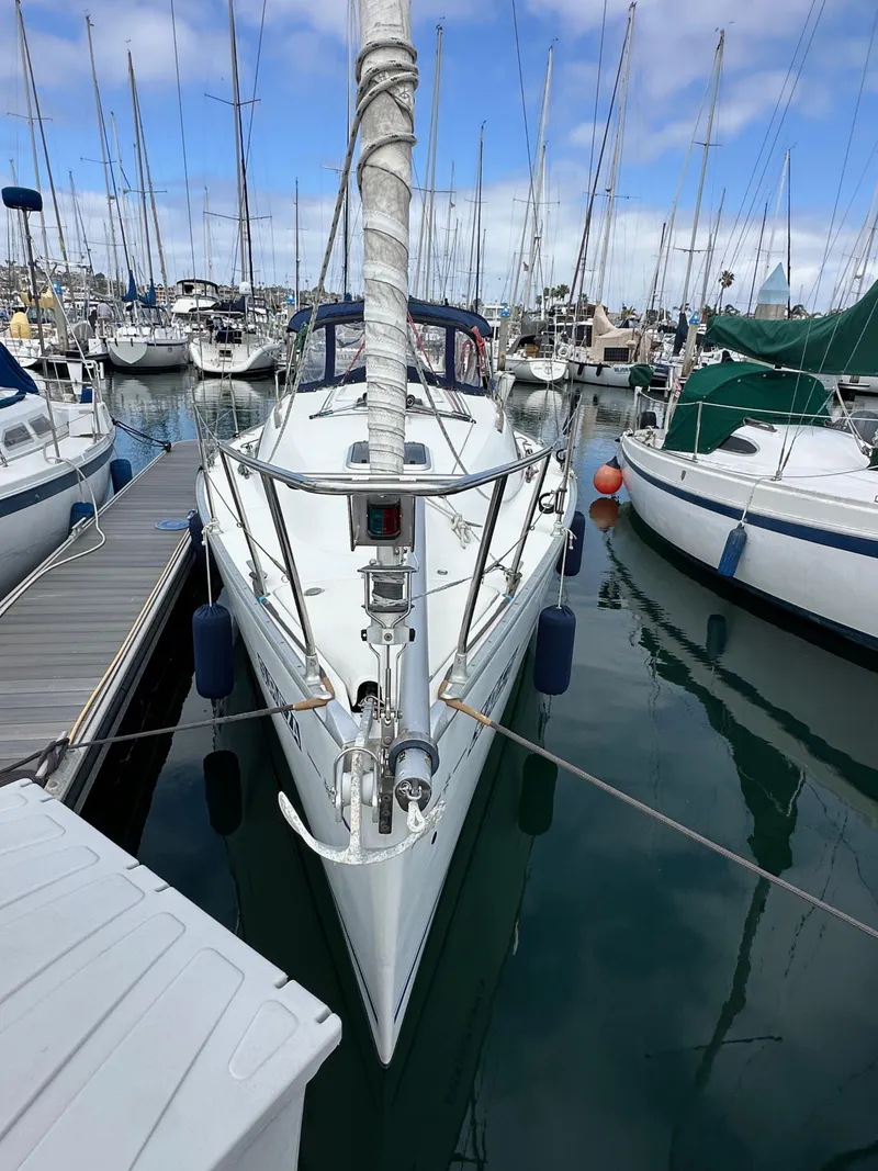 Slide: The Image of 2003 Jeanneau Sun Odyssey 32 sailboat docked in a marina. - 2