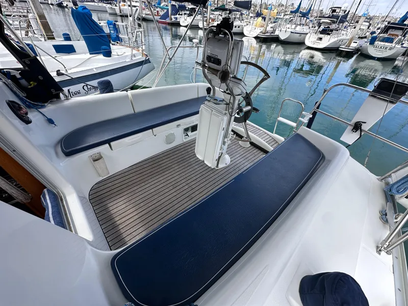 Slide: The Image of 2003 Jeanneau Sun Odyssey 32 sailboat cockpit with blue seating, docked in marina. - 23