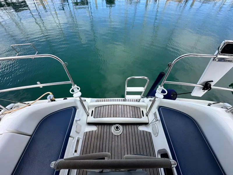 Slide: The Image of Jeanneau Sun Odyssey 32 yacht stern view, 2003 model, with teak deck and blue seating. - 26
