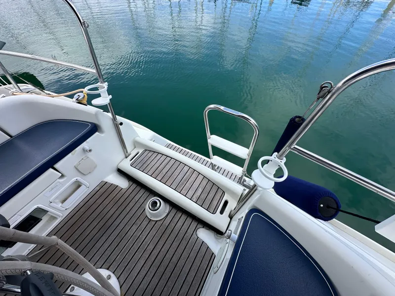 Slide: The Image of Cockpit of 2003 Jeanneau Sun Odyssey 32 sailboat with teak flooring and blue seating. - 27