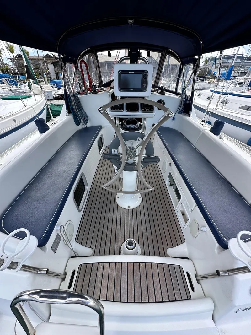 Slide: The Image of 2003 Jeanneau Sun Odyssey 32 cockpit with steering wheel and navigation equipment. - 29
