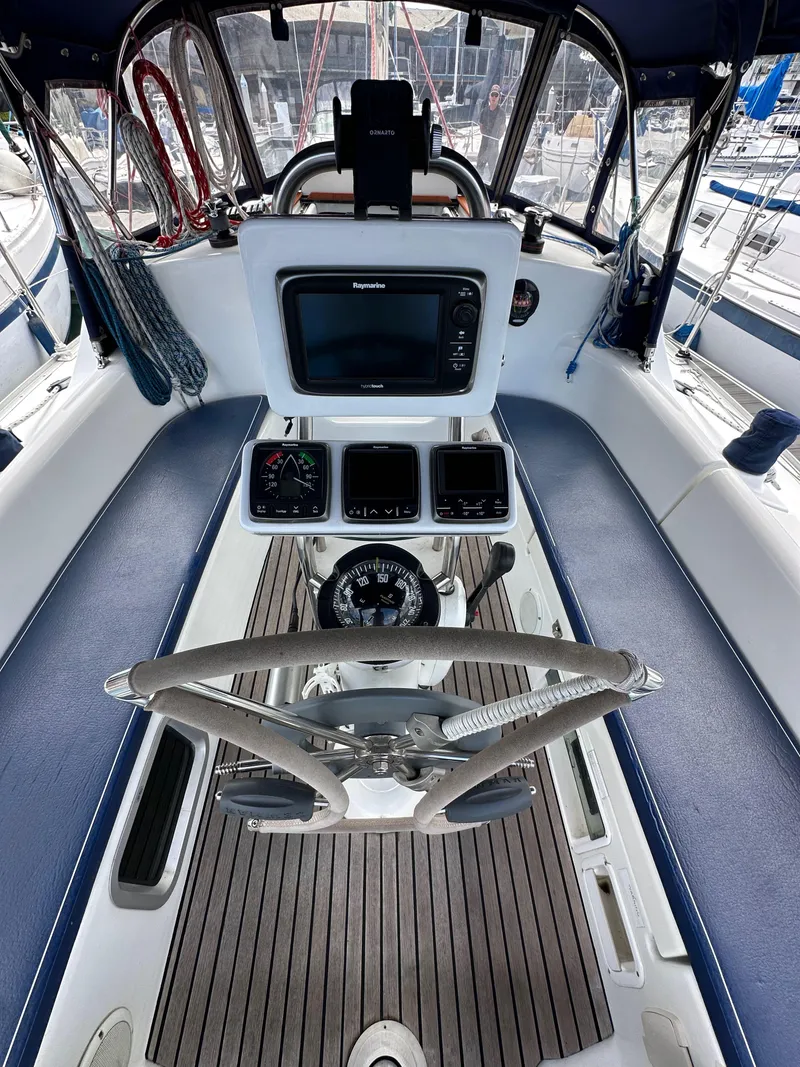 Slide: The Image of 2003 Jeanneau Sun Odyssey 32 cockpit with steering wheel and navigation instruments. - 31