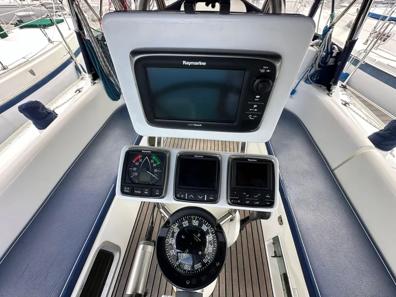 Slide: The Image of Cockpit of 2003 Jeanneau Sun Odyssey 32 with navigation instruments and compass. - 32