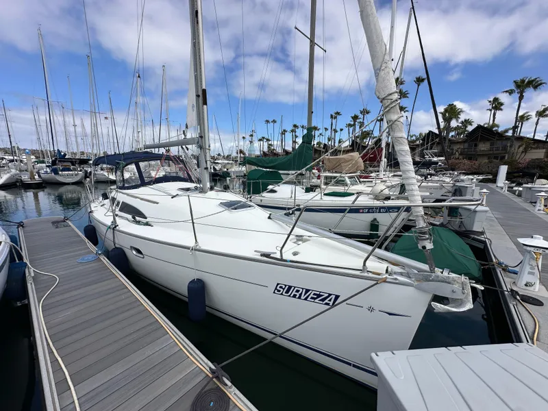 Slide: The Image of 2003 Jeanneau Sun Odyssey 32 sailboat docked at marina under blue sky. - 4