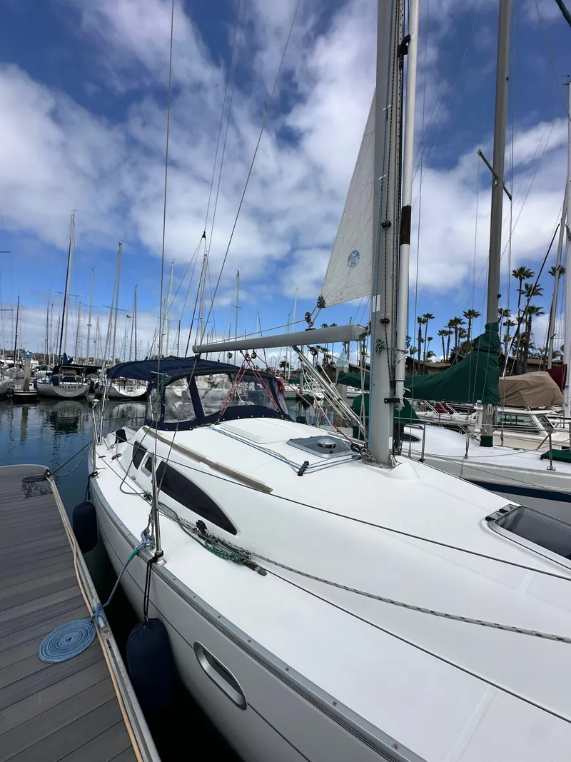 Slide: The Image of 2003 Jeanneau Sun Odyssey 32 sailboat docked at marina under blue sky. - 5