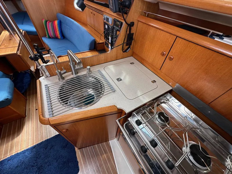 Slide: The Image of Interior of 2003 Jeanneau Sun Odyssey 32 yacht with kitchen and seating area. - 50