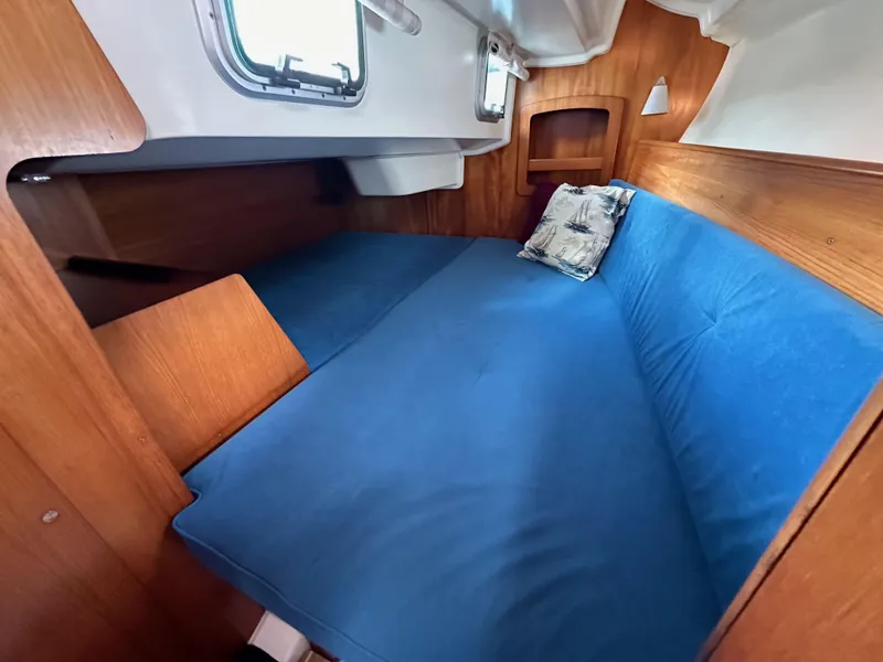 Slide: The Image of Cozy cabin interior of 2003 Jeanneau Sun Odyssey 32 sailboat with blue cushions. - 54