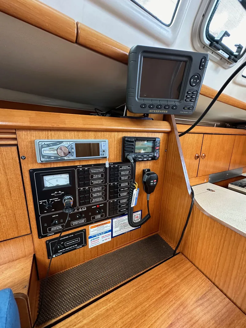Slide: The Image of Control panel of 2003 Jeanneau Sun Odyssey 32 sailboat with navigation equipment. - 58