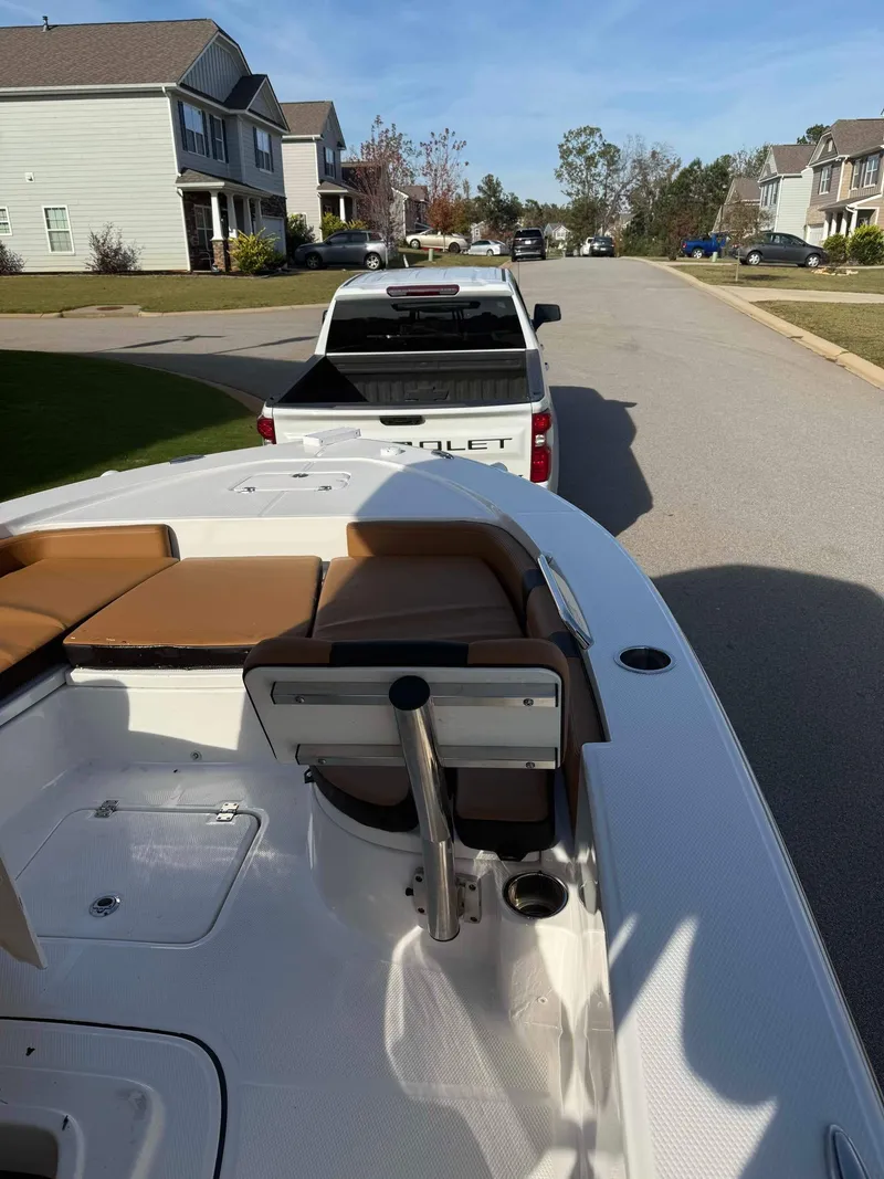 Slide: The Image of 2024 Robalo 226 Cayman boat on trailer, parked in suburban neighborhood street. - 8