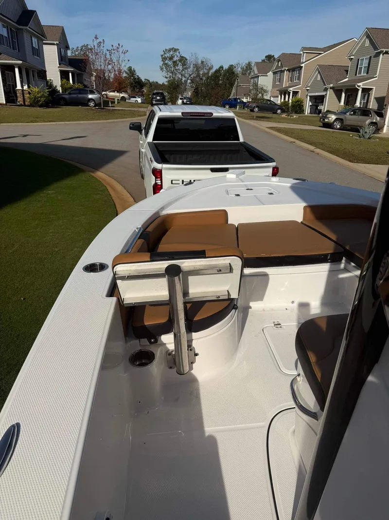 Slide: The Image of 2024 Robalo 226 Cayman boat on trailer in suburban neighborhood. - 9