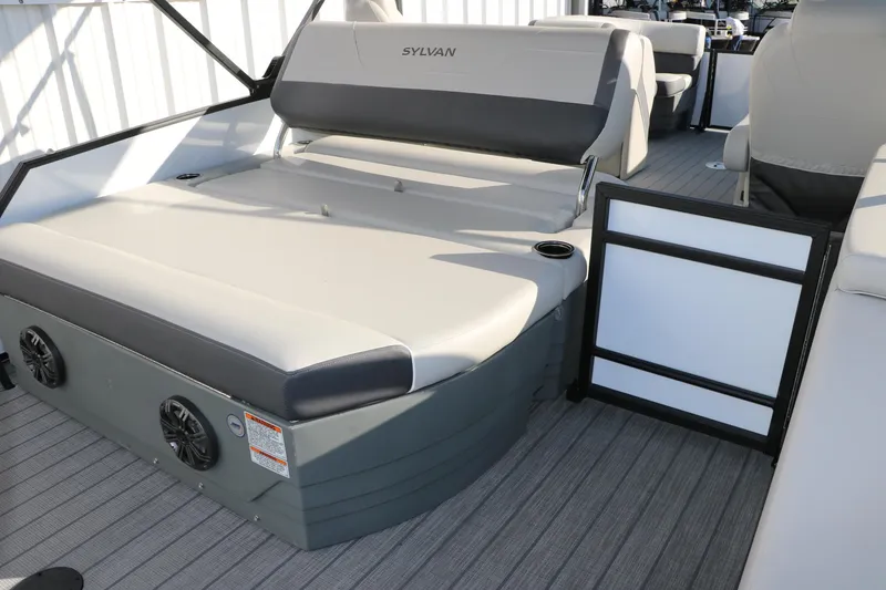 Slide: The Image of 2025 Sylvan Mirage X X1 CLZ DH boat interior with cushioned seating and speakers. - 19