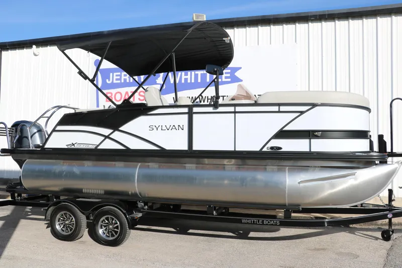 Slide: The Image of 2025 Sylvan Mirage X X1 CLZ DH pontoon boat with canopy on trailer. - 2
