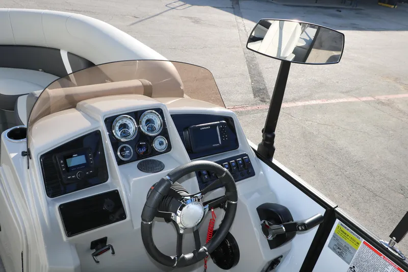 Slide: The Image of 2025 Sylvan Mirage X X1 CLZ DH boat dashboard with steering wheel and control panel. - 27