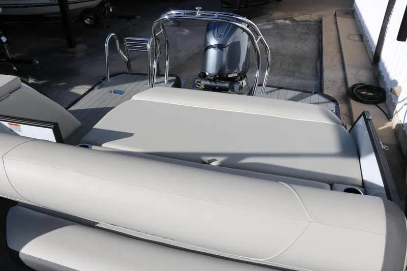 Slide: The Image of 2025 Sylvan Mirage X X1 CLZ DH boat with sleek seating and modern outboard motor. - 31