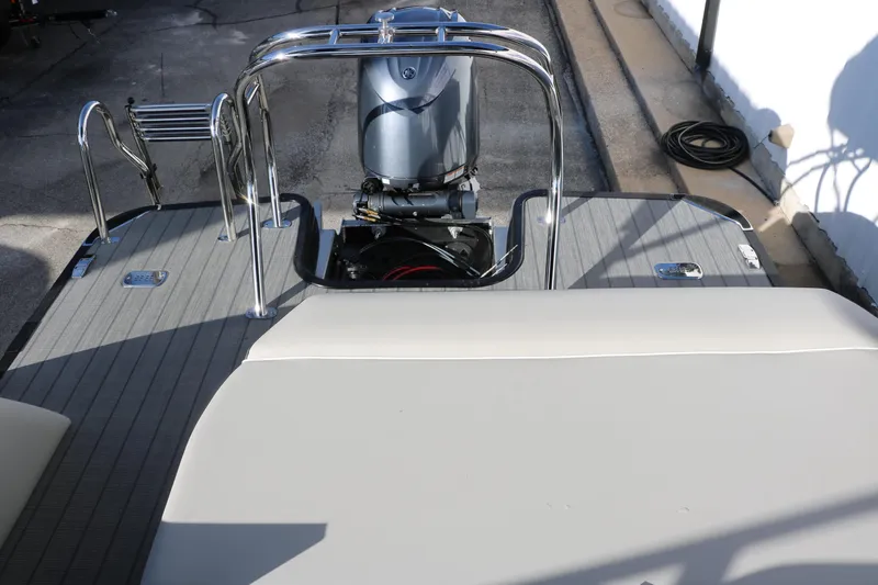 Slide: The Image of 2025 Sylvan Mirage X X1 CLZ DH boat with outboard motor and seating area. - 32