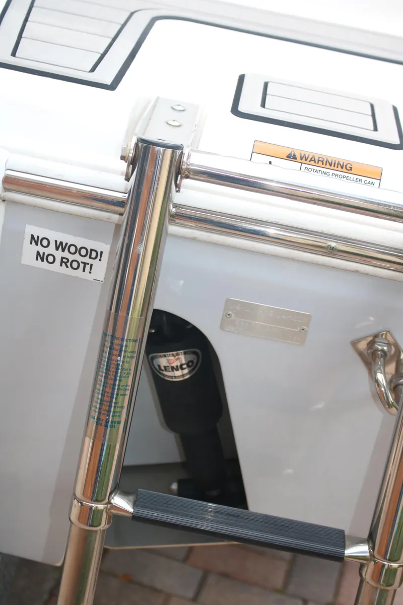 Slide: The Image of 2023 Sea Fox 228 boat ladder with "No Wood! No Rot!" sticker and warning label. - 12
