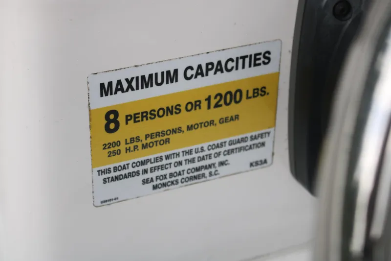 Slide: The Image of Sea Fox 228 boat capacity label, 8 persons or 1200 lbs, 2023 model. - 13