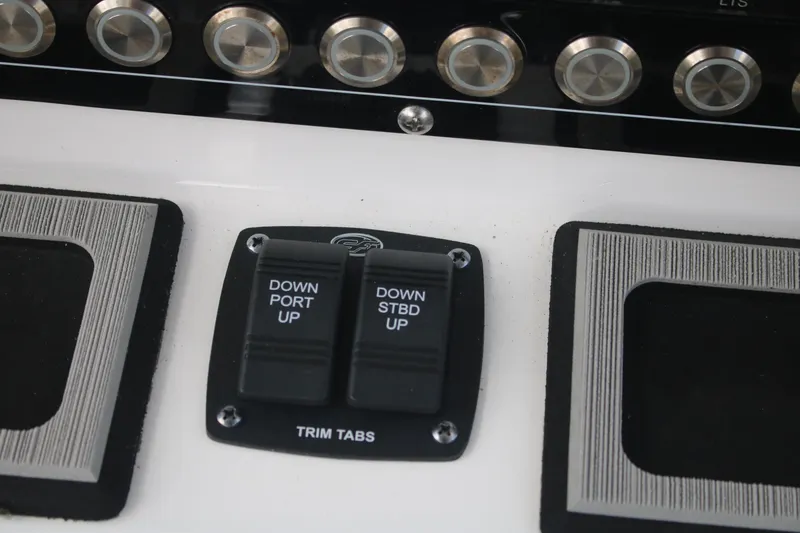 Slide: The Image of Control panel of 2023 Sea Fox 228 boat with trim tab switches. - 14