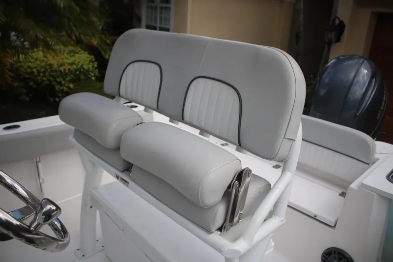 Slide: The Image of 2023 Sea Fox 228 boat with cushioned seating and steering wheel. - 22